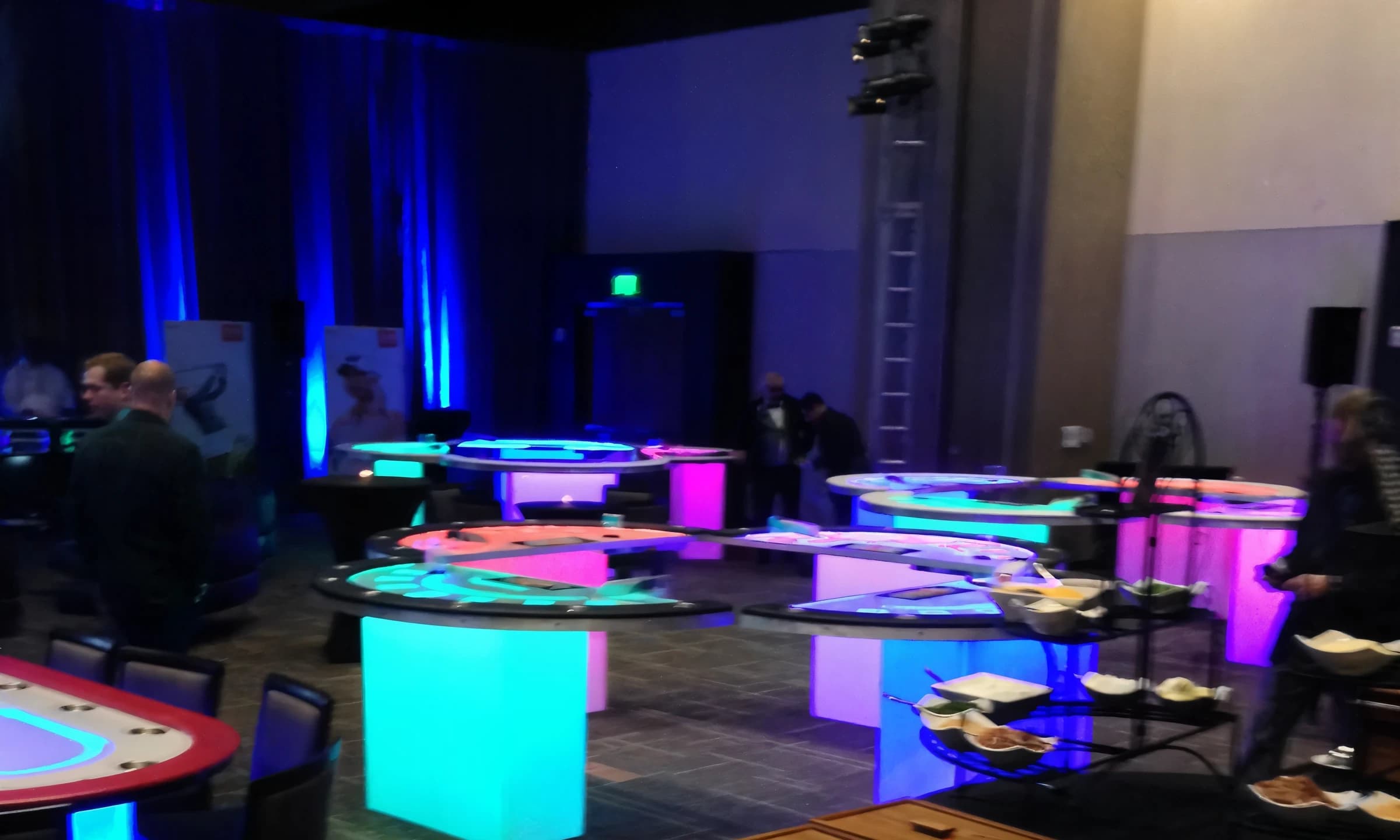 Uniformed dealer running a glow casino table for guests