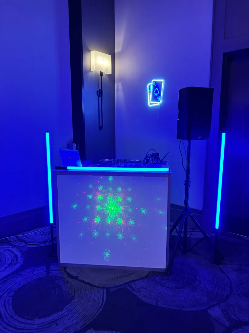 DJ booth with glow lighting and laser projection
