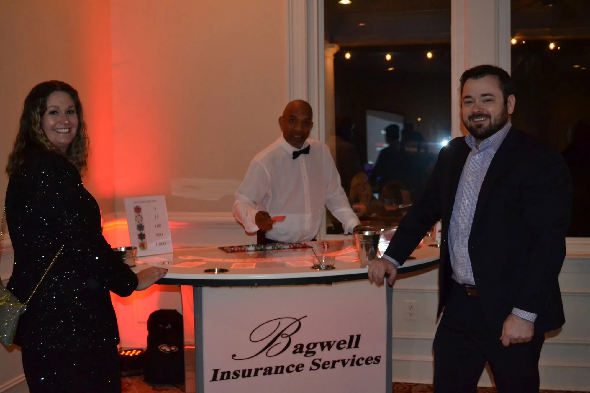 Glow blackjack table carrying Bagwell Insurance Services sponsor branding at a charity casino night