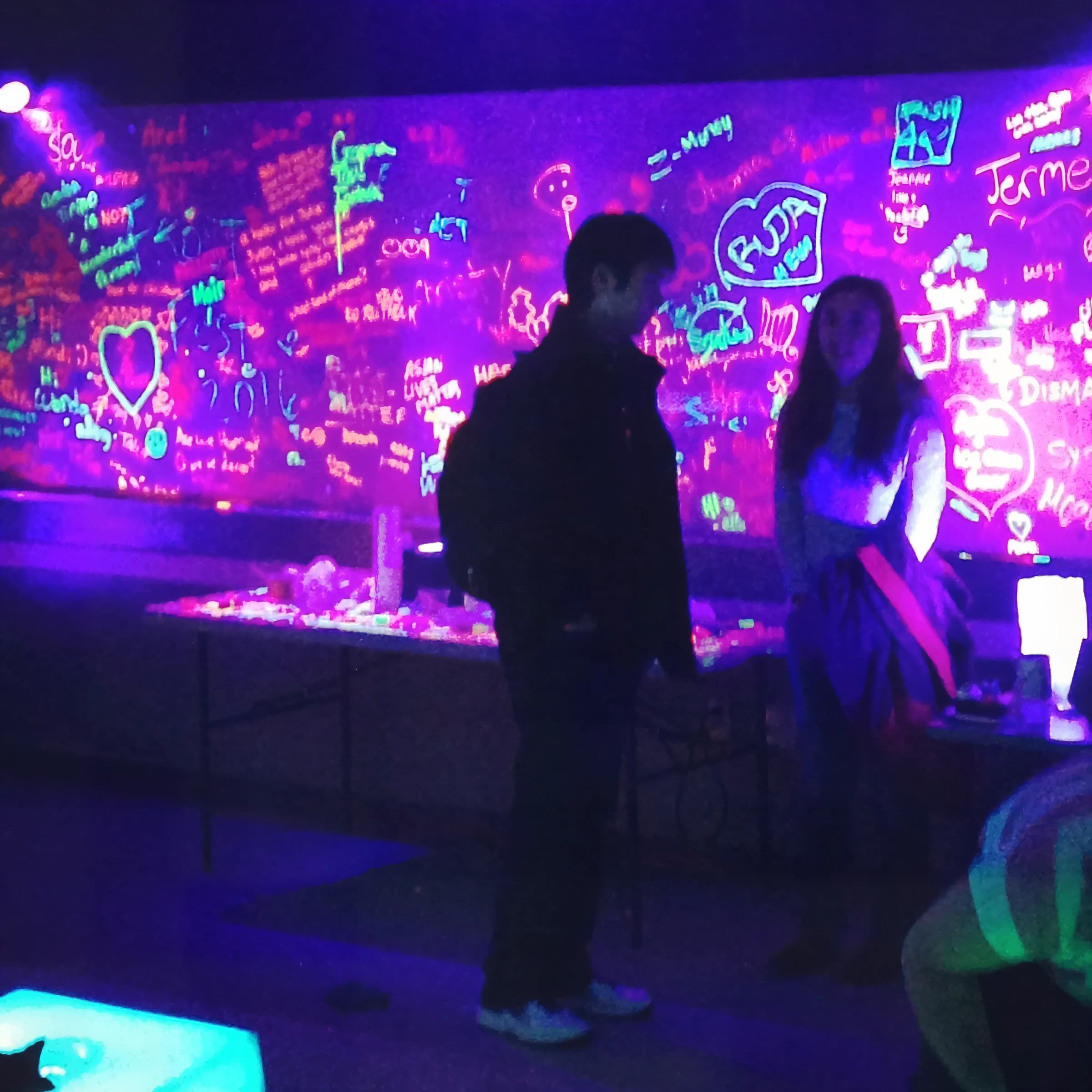 Glow team-building activity with guests in a darkened room
