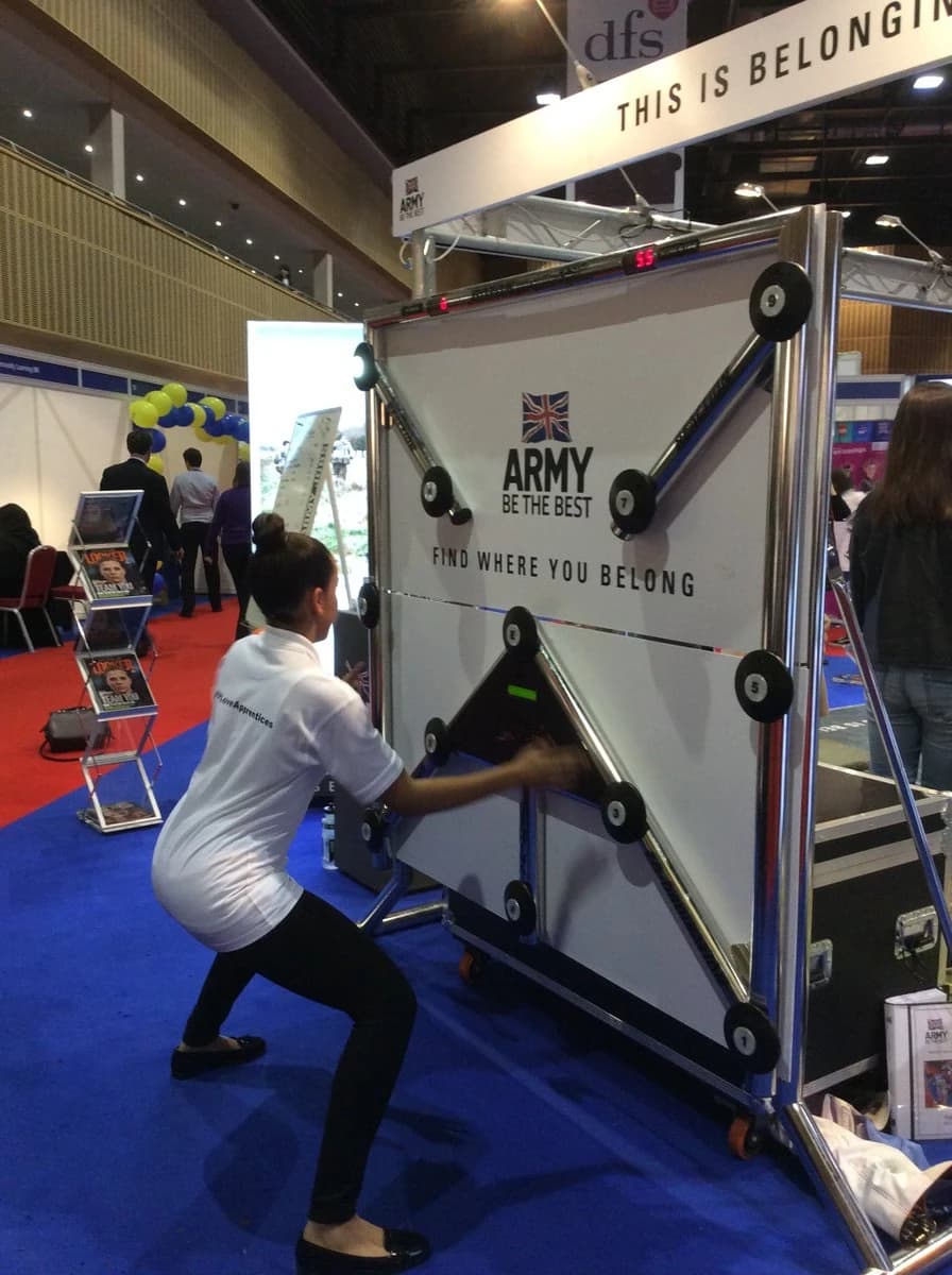 Guest playing the BATAK reaction wall at a branded exhibition stand