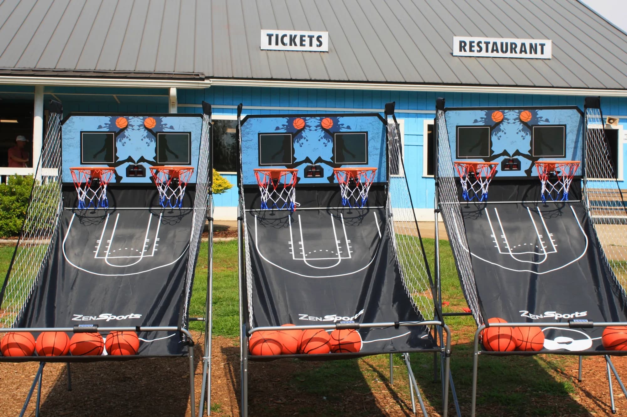 Three Double Pop-A-Shot basketball units lined up and ready to play