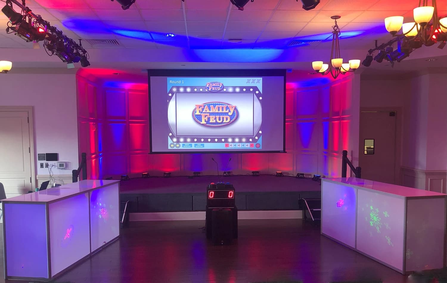 Game show stage with contestants and a live host
